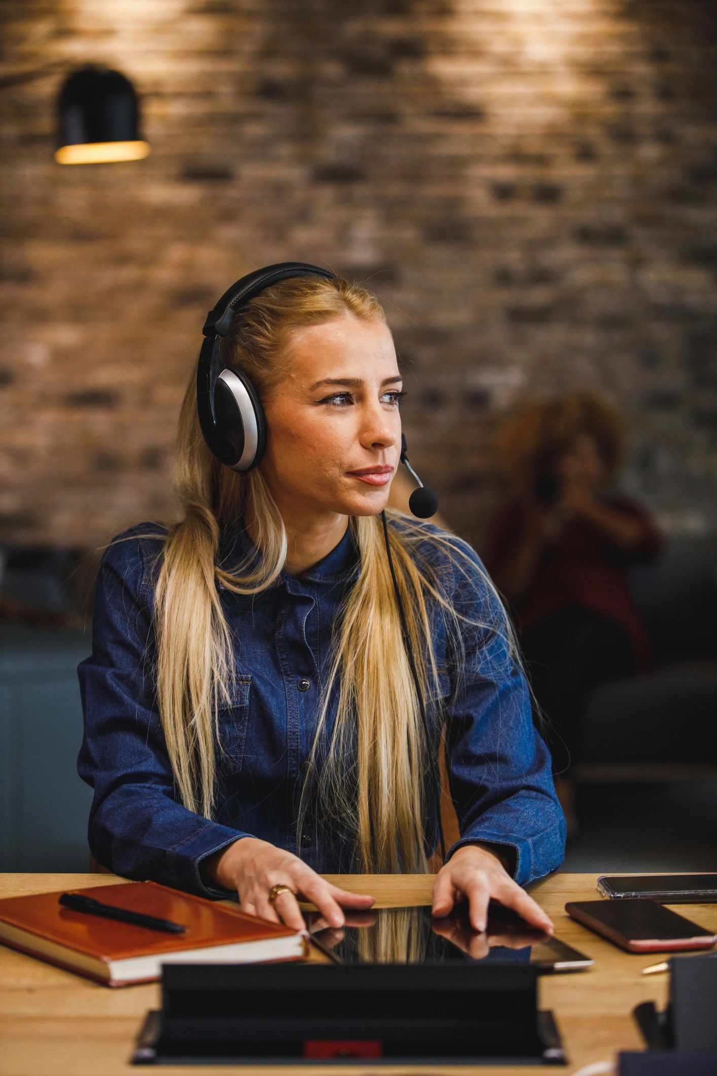 Customer support professional wearing a headset and smiling
